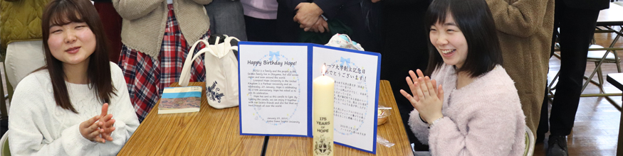 people smiling and posing with commemorative candles